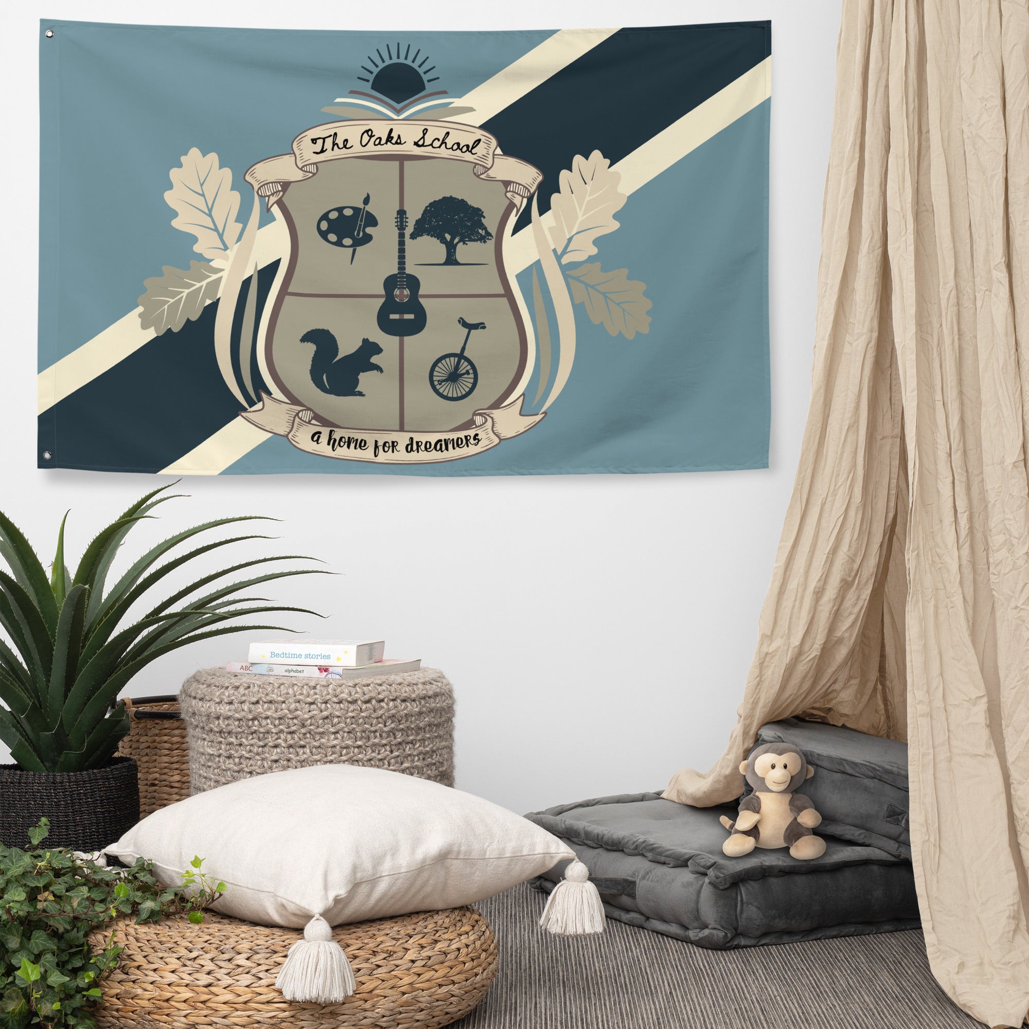 Product mockup: Illustration of a navy, blue, and cream colored flag hanging on the wall of a lounging room featuring a crest with an art palette, oak tree, squirrel, guitar, and unicycle and a thick diagonal stripe behind the crest