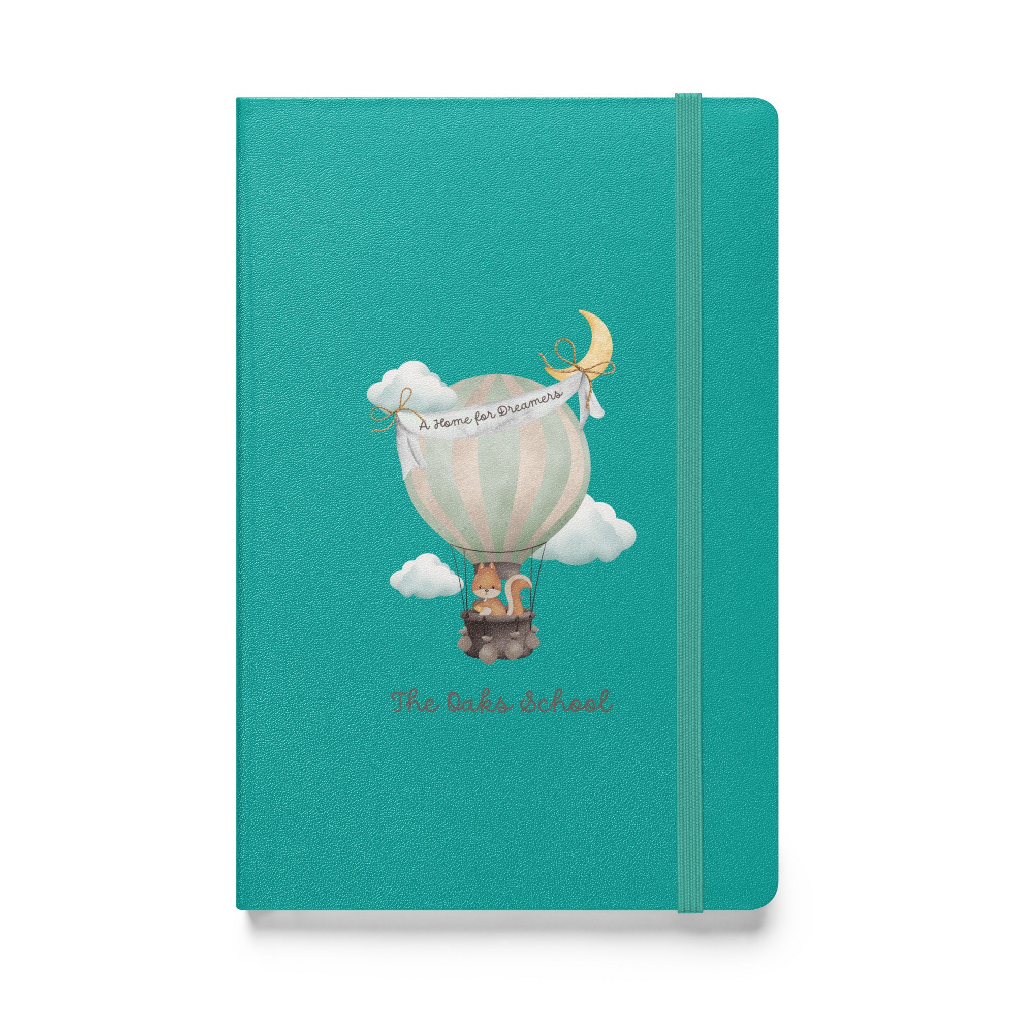 Product mockup: A turquoise colored journal on a white background featuring a hot air balloon containing a squirrel and text that says "The Oaks School" and "A Home for Dreamers."