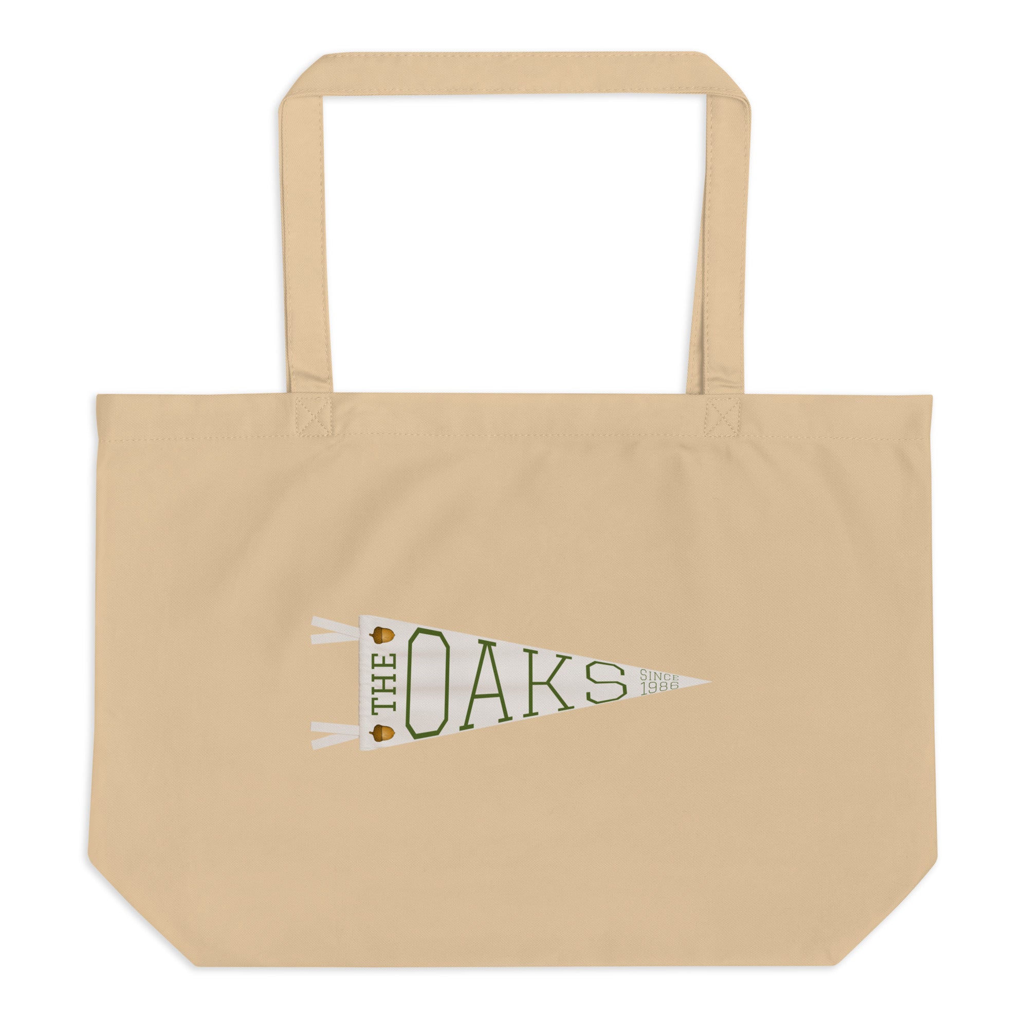 Product mockup: A taupe colored canvas bag on a white background featuring a pennant that says "The Oaks Since 1986" and two acorns