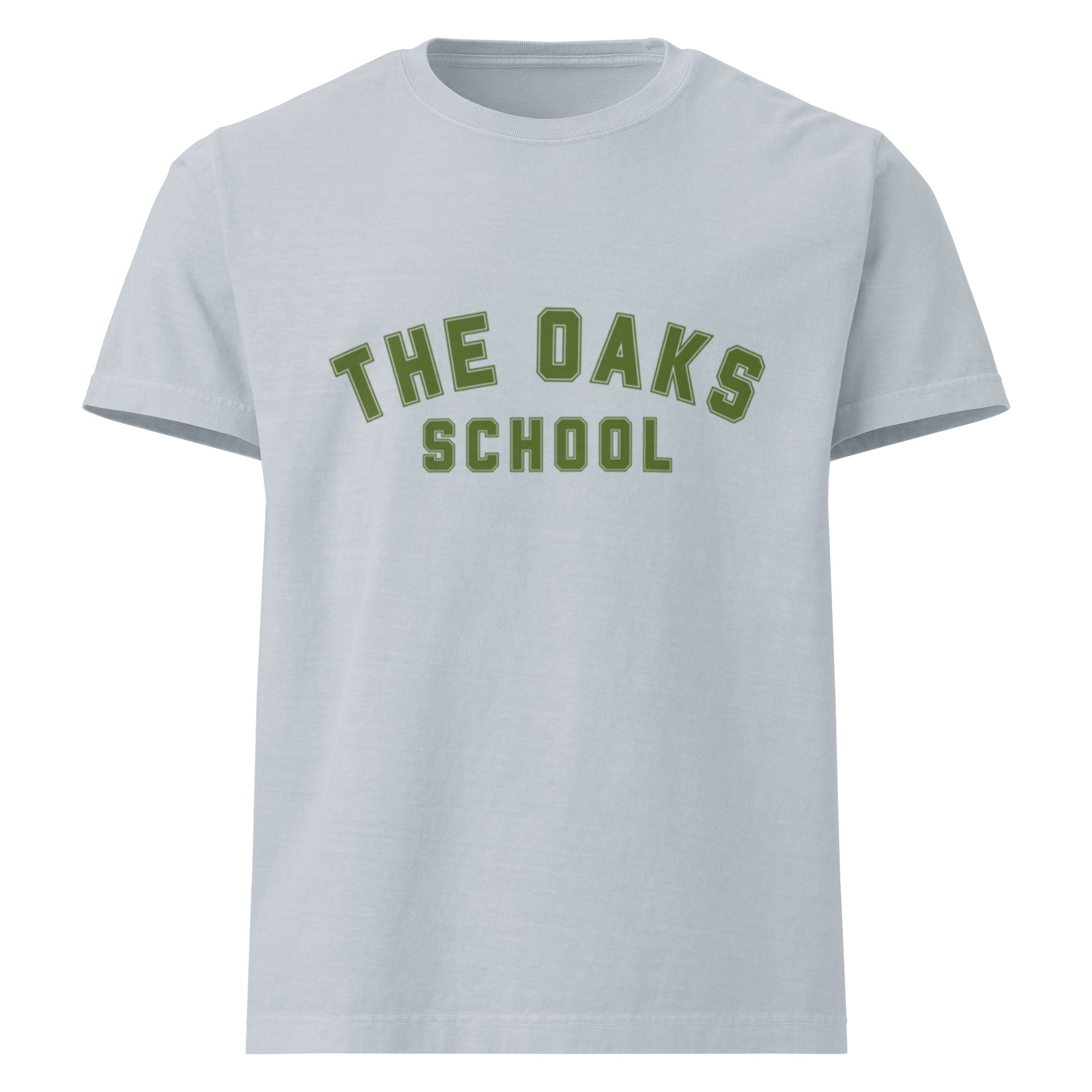 Product mockup: A washed denim tshirt on a white background with green collegiate style lettering that says "The Oaks School"