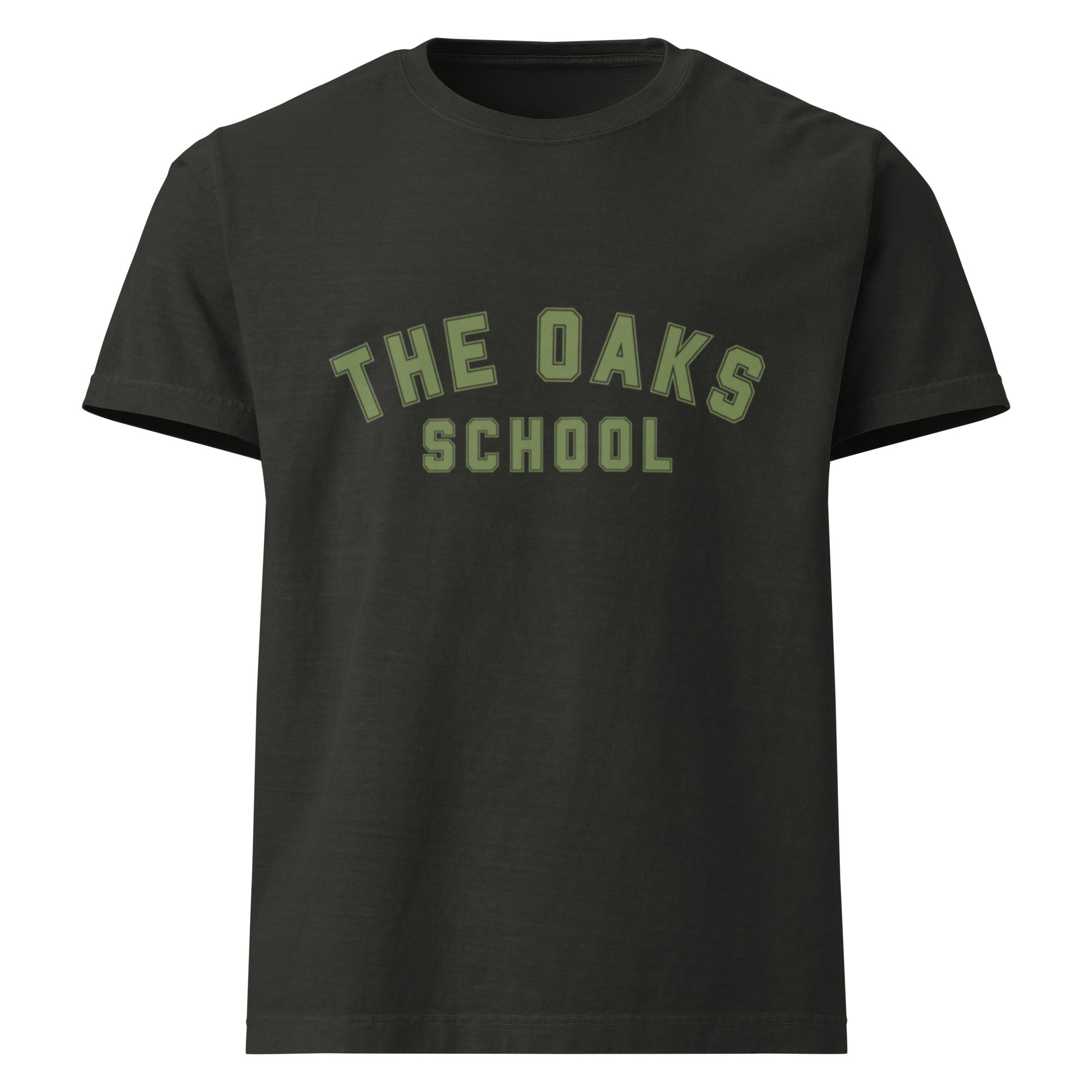 Product mockup: A washed black tshirt on a white background with green collegiate style lettering that says "The Oaks School"