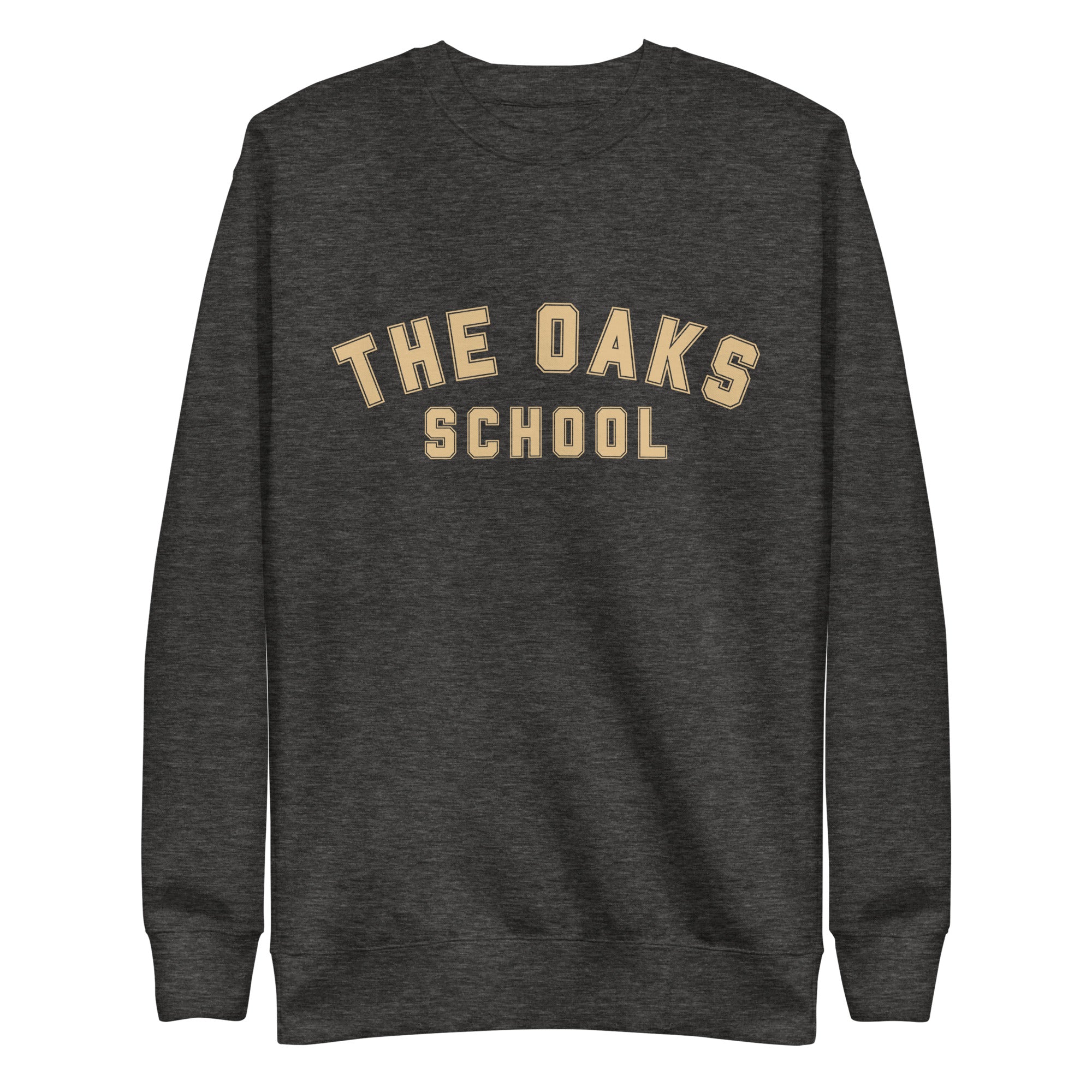 Product mockup: A charcoal heather sweatshirt on a white background with cream colored collegiate style lettering that says "The Oaks School"