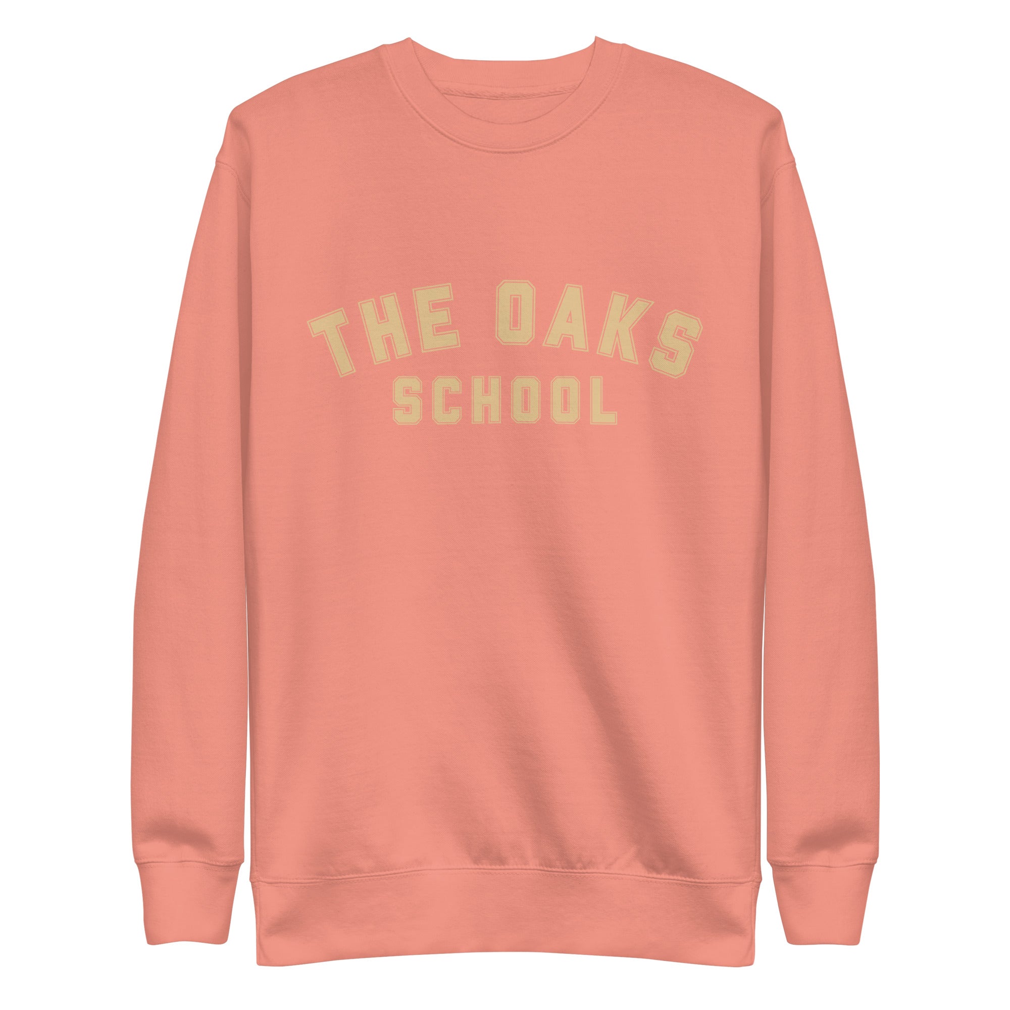 Product mockup: A dusty rose colored sweatshirt on a white background with cream colored collegiate style lettering that says "The Oaks School"