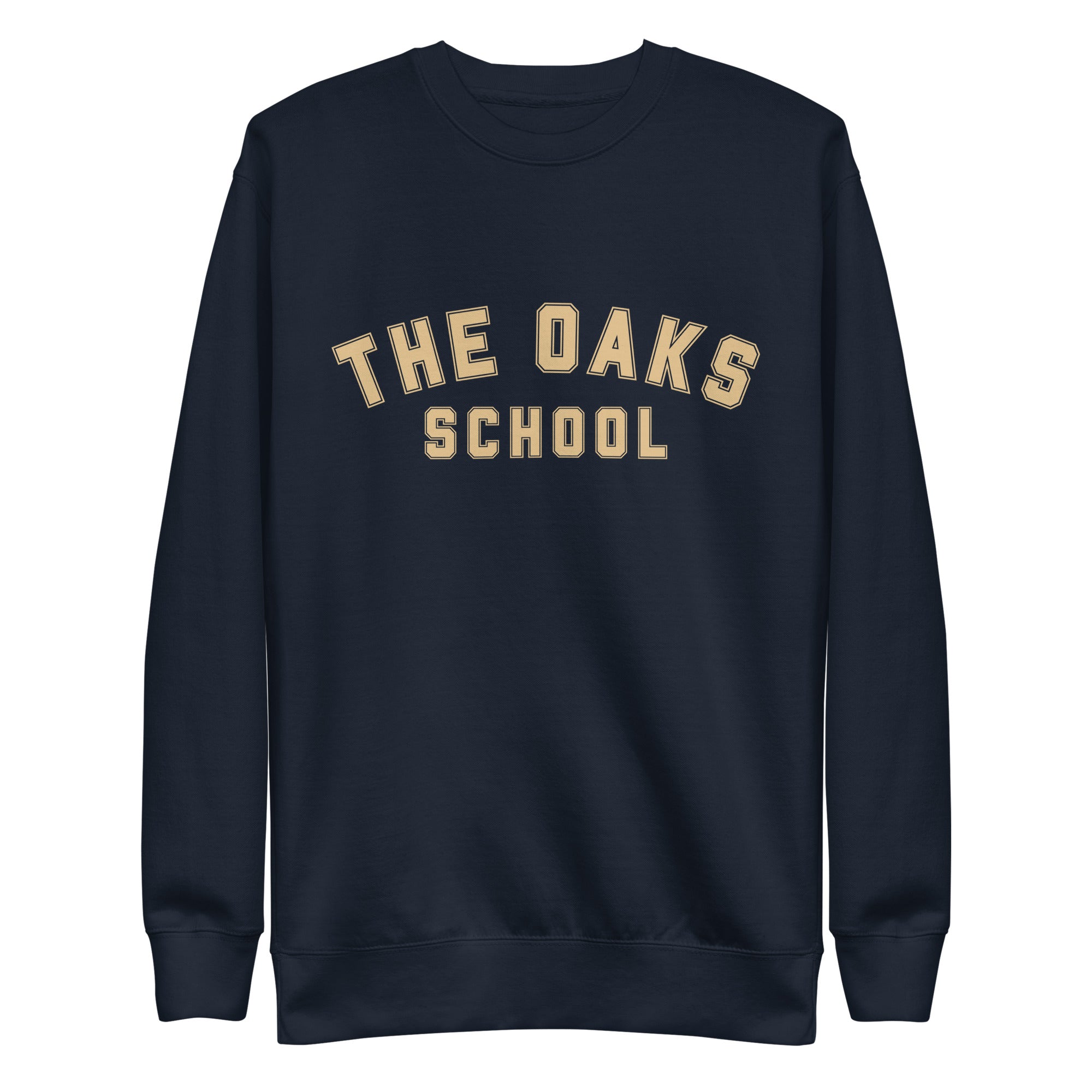 Product mockup: A navy sweatshirt on a white background with cream colored collegiate style lettering that says "The Oaks School"