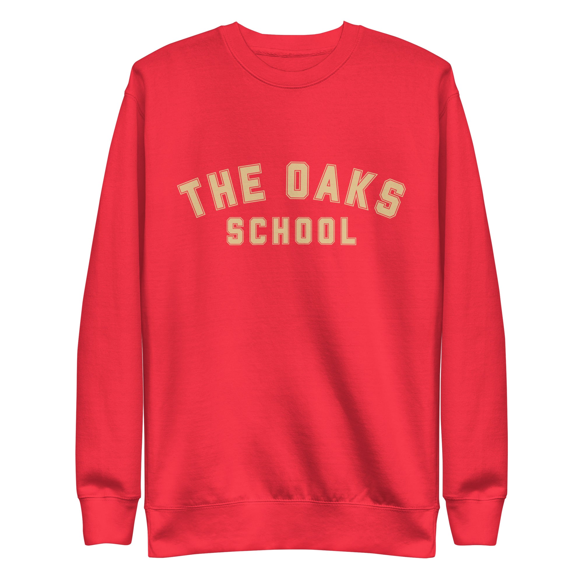 Product mockup: A red sweatshirt on a white background with cream colored collegiate style lettering that says "The Oaks School"