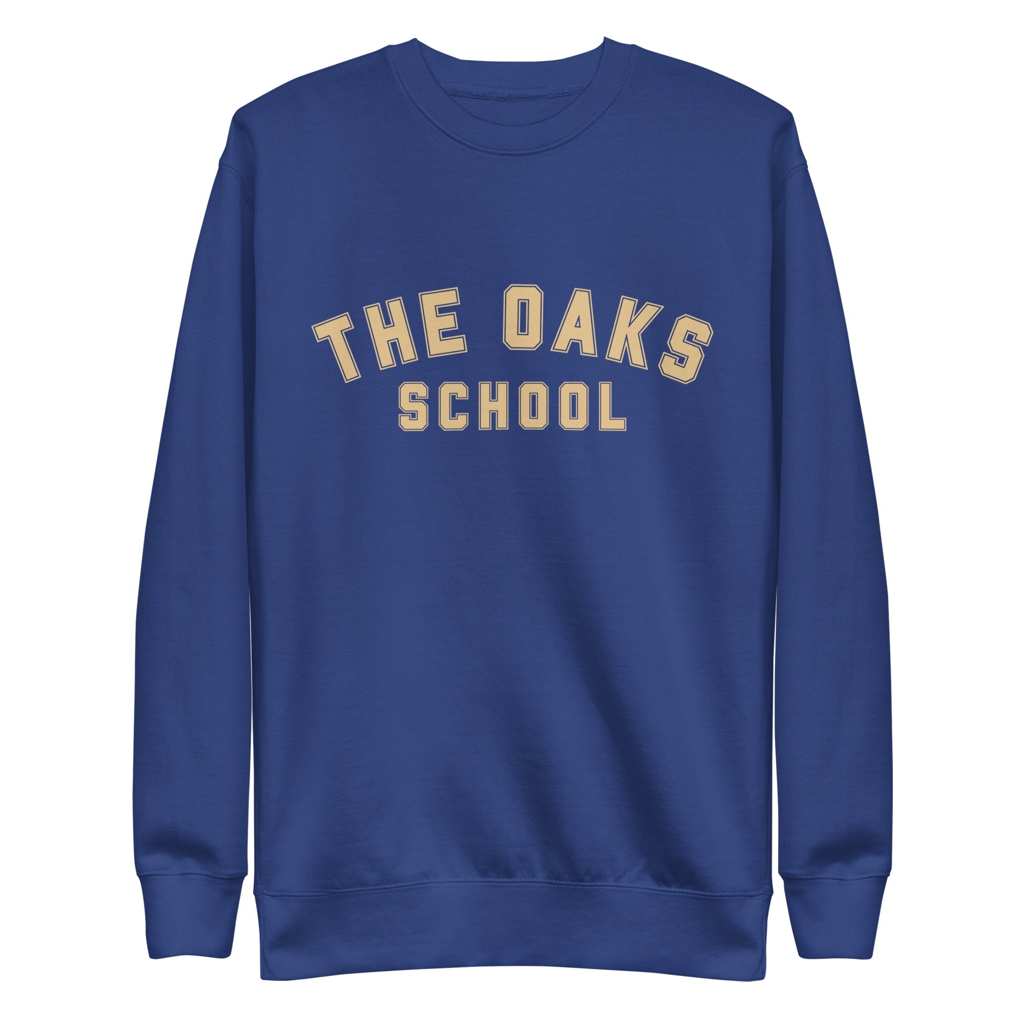 Product mockup: A royal blue sweatshirt on a white background with cream colored collegiate style lettering that says "The Oaks School"