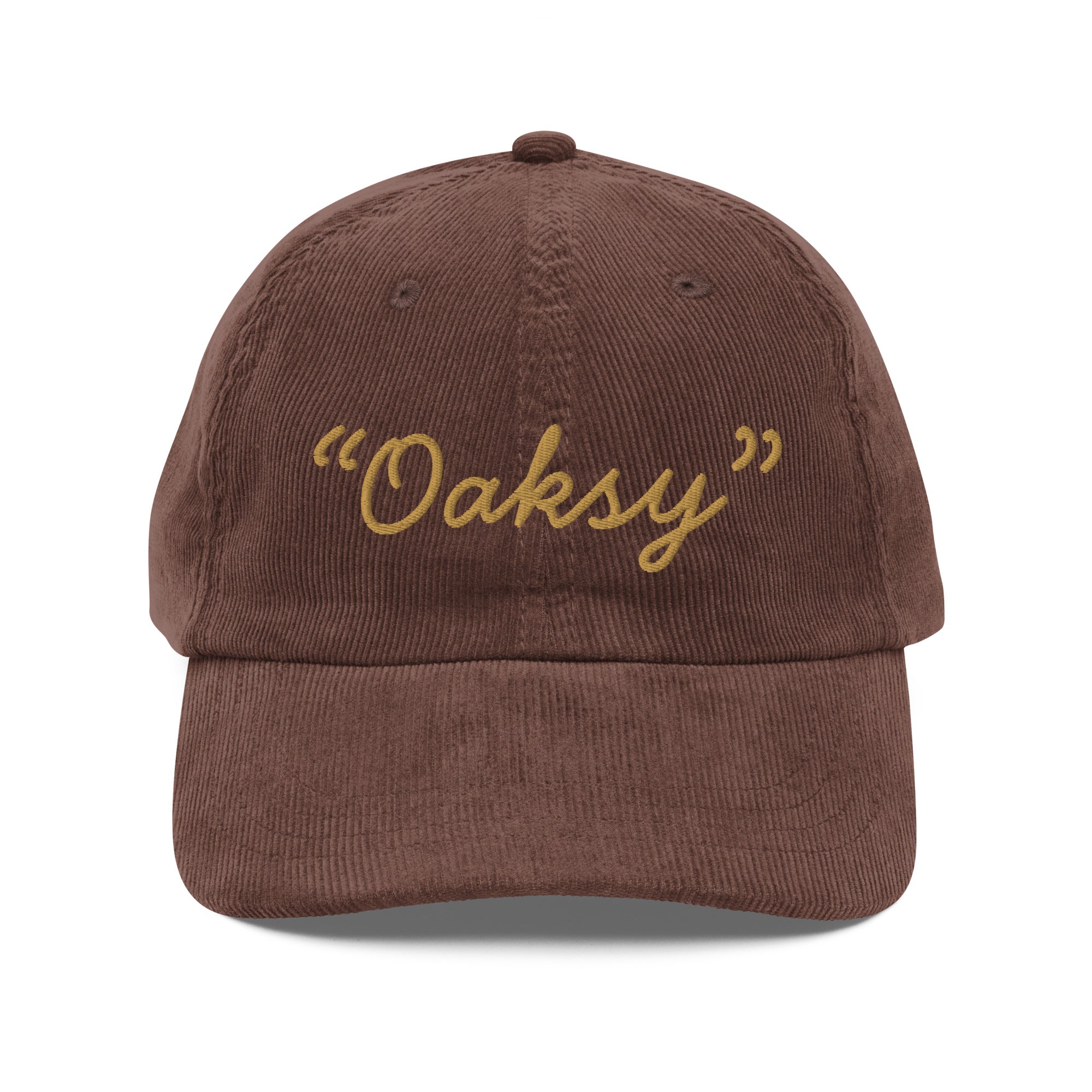 Product mockup:  A brown corduroy cap on a white background featuring gold lettering in a handwriting font that says "Oaksy" in quotes