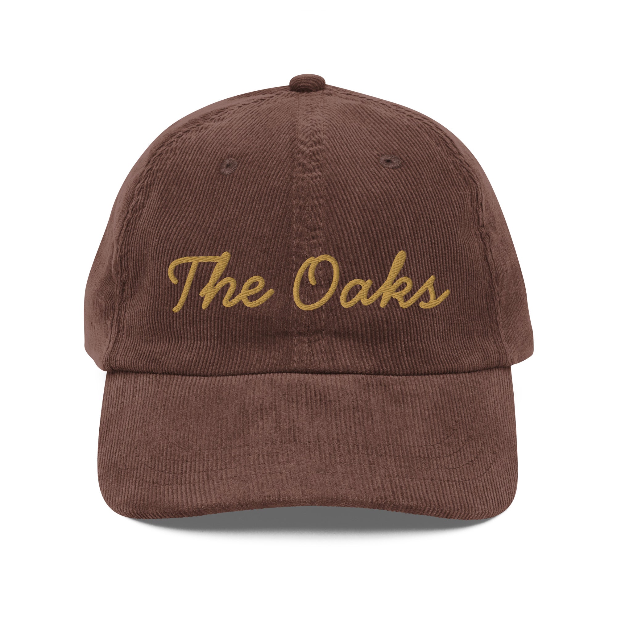 Product mockup: An brown colored corduroy cap on a white background featuring gold lettering in a handwriting font that says "The Oaks"