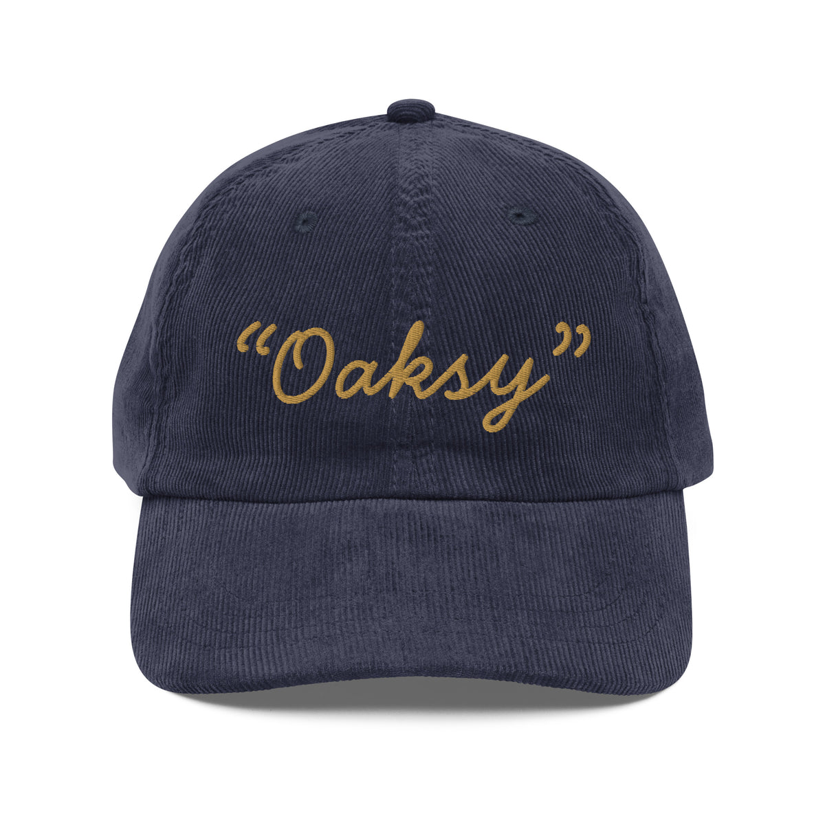 Product mockup:  A navy corduroy cap on a white background featuring gold lettering in a handwriting font that says "Oaksy" in quotes