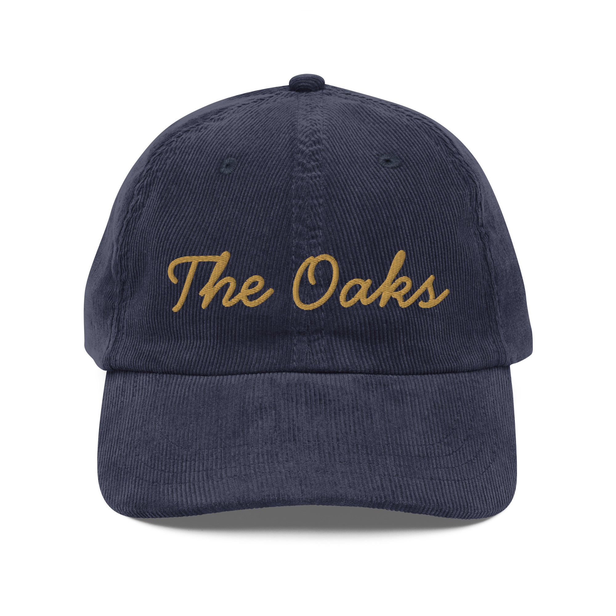 Product mockup: An navy colored corduroy cap on a white background featuring gold lettering in a handwriting font that says "The Oaks"