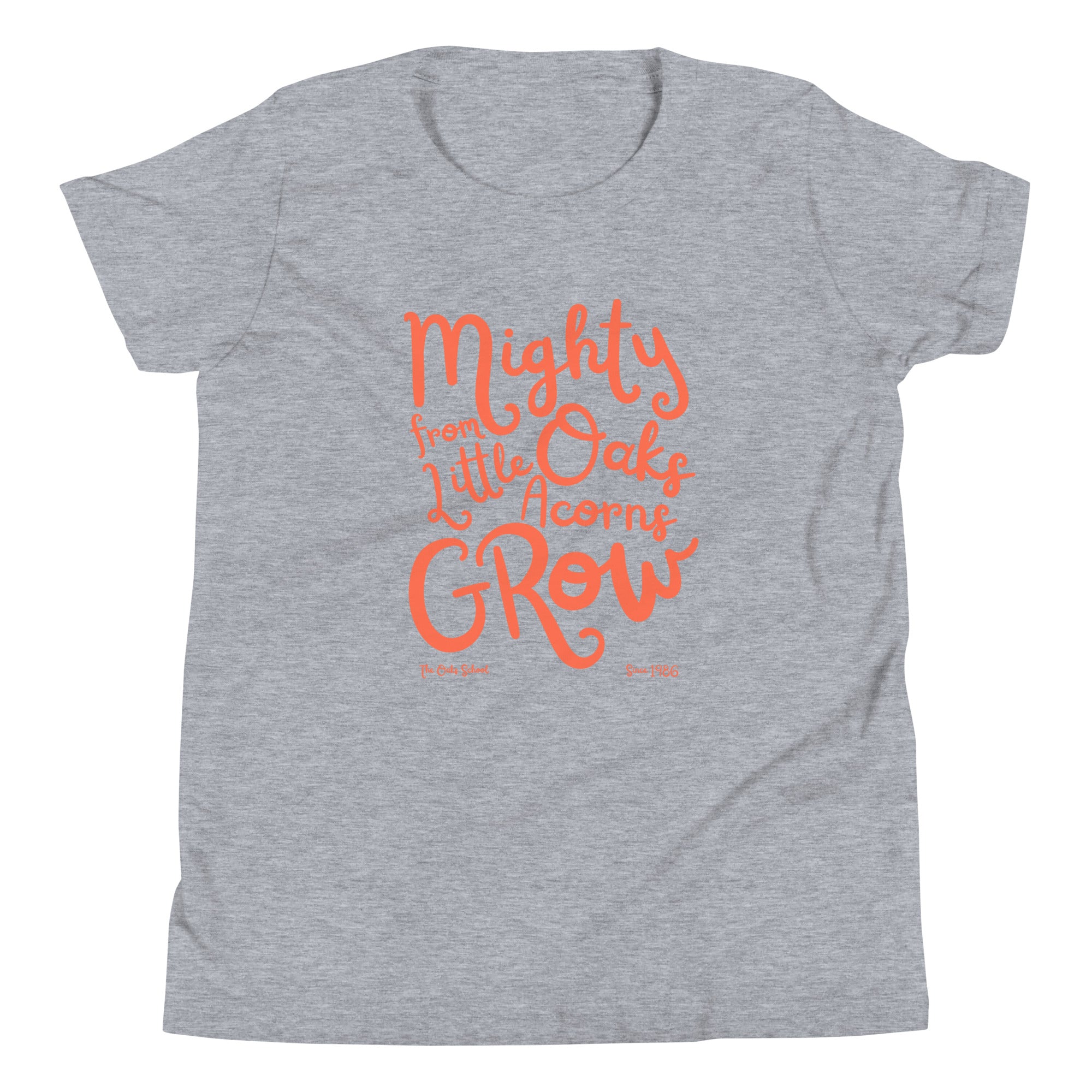 Product mockup: A heather gray tshirt on a white background with orange script text that says "Mighty Oaks from Little Acorns Grow" and "The Oaks School Since 1986"