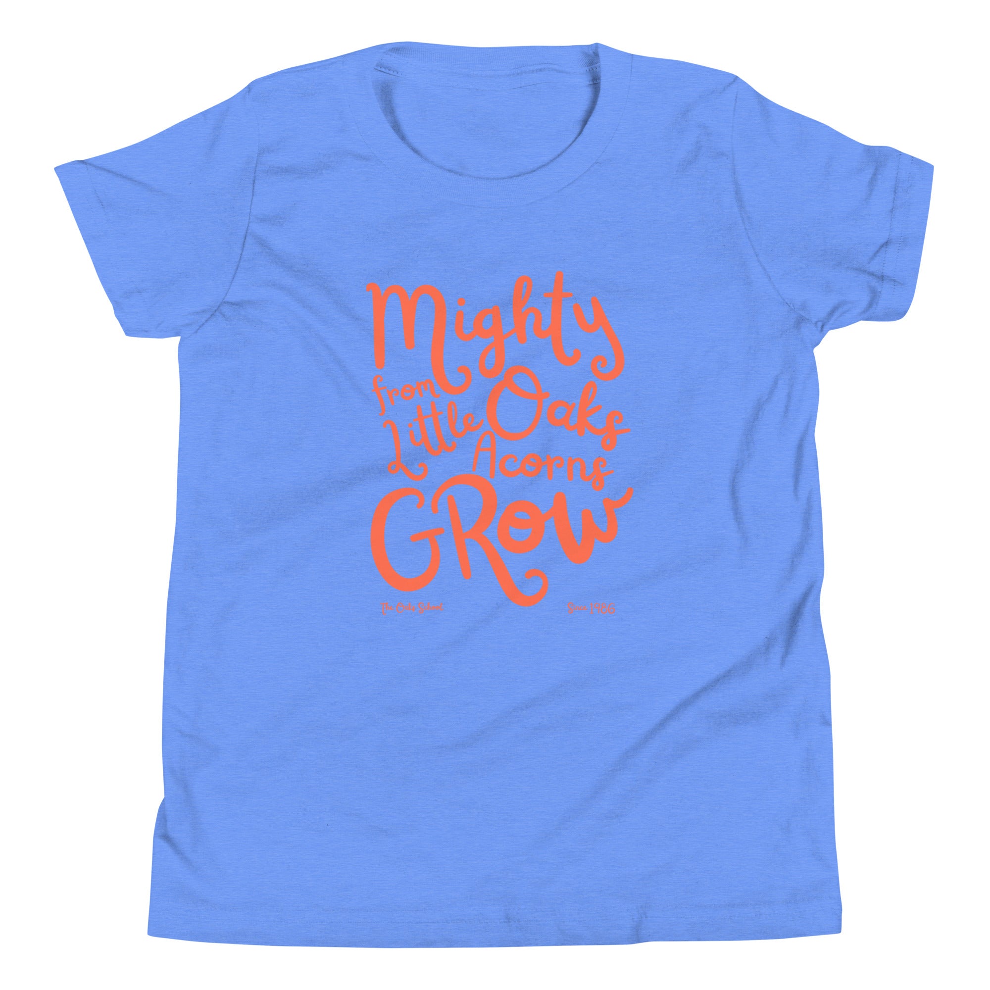 Product mockup: A heather bright blue tshirt on a white background with orange script text that says "Mighty Oaks from Little Acorns Grow" and "The Oaks School Since 1986"