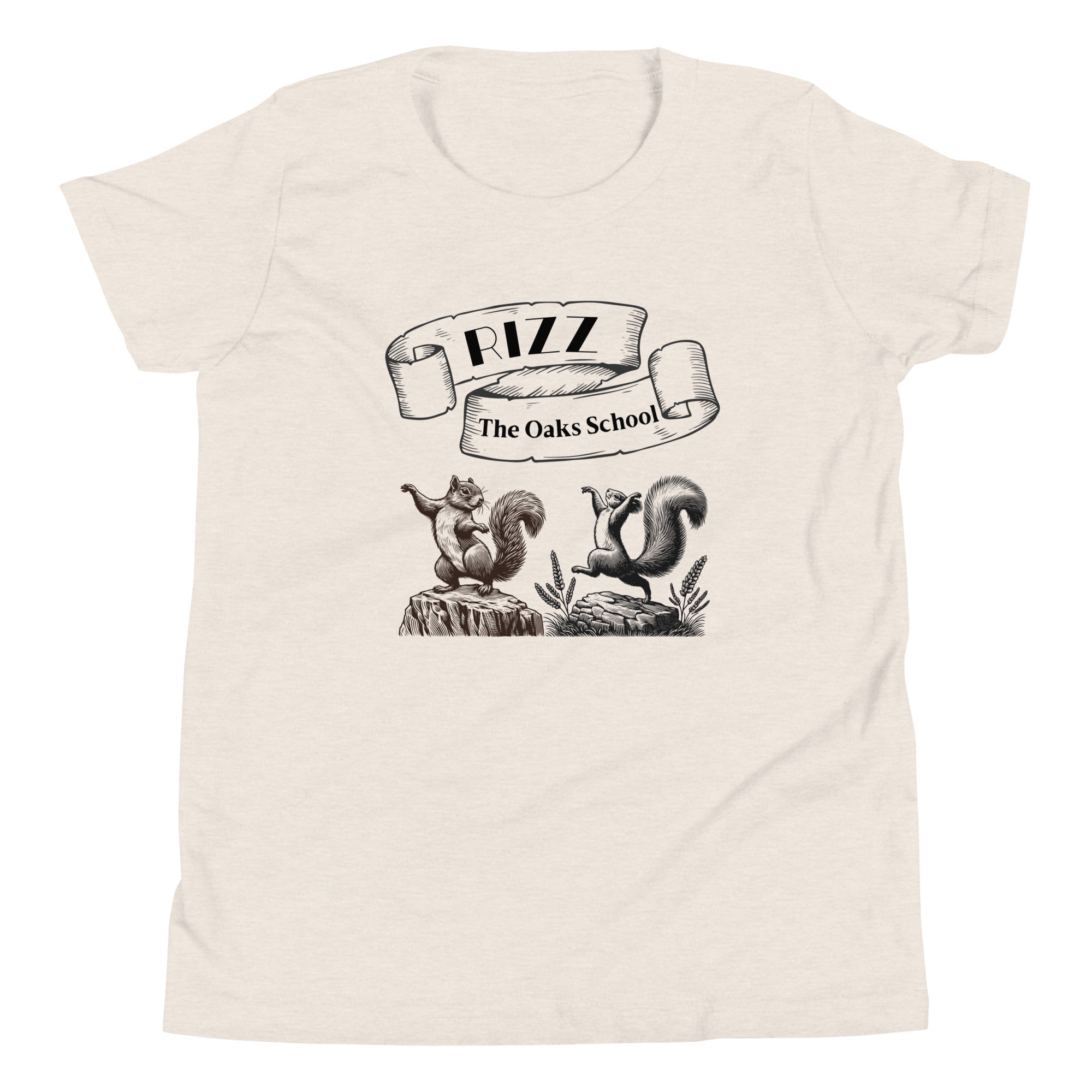 Product mockup: A heather dust colored tshirt on a white background featuring an illustration of two squirrels dancing on stumps with a scroll above them with the text "Rizz" and "The Oaks School."