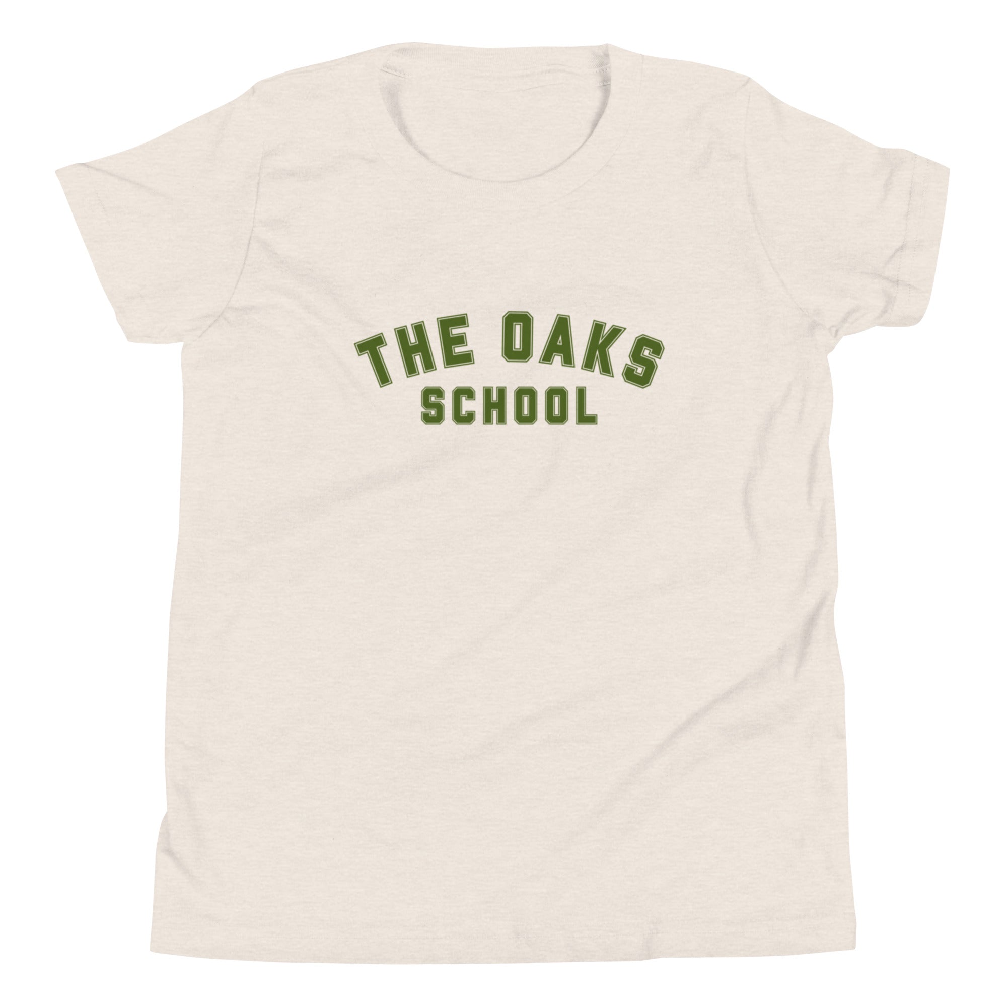 Product mockup: A heather dust colored tshirt on a white background featuring green collegiate style lettering that says "The Oaks School"