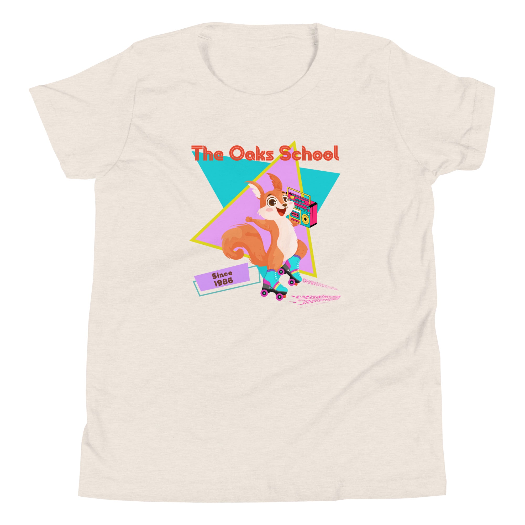 Product mockup: Cream colored tshirt on white background featuring a squirrel with roller skates holding a boombox and text that reads "The Oaks School" and "Since 1986"