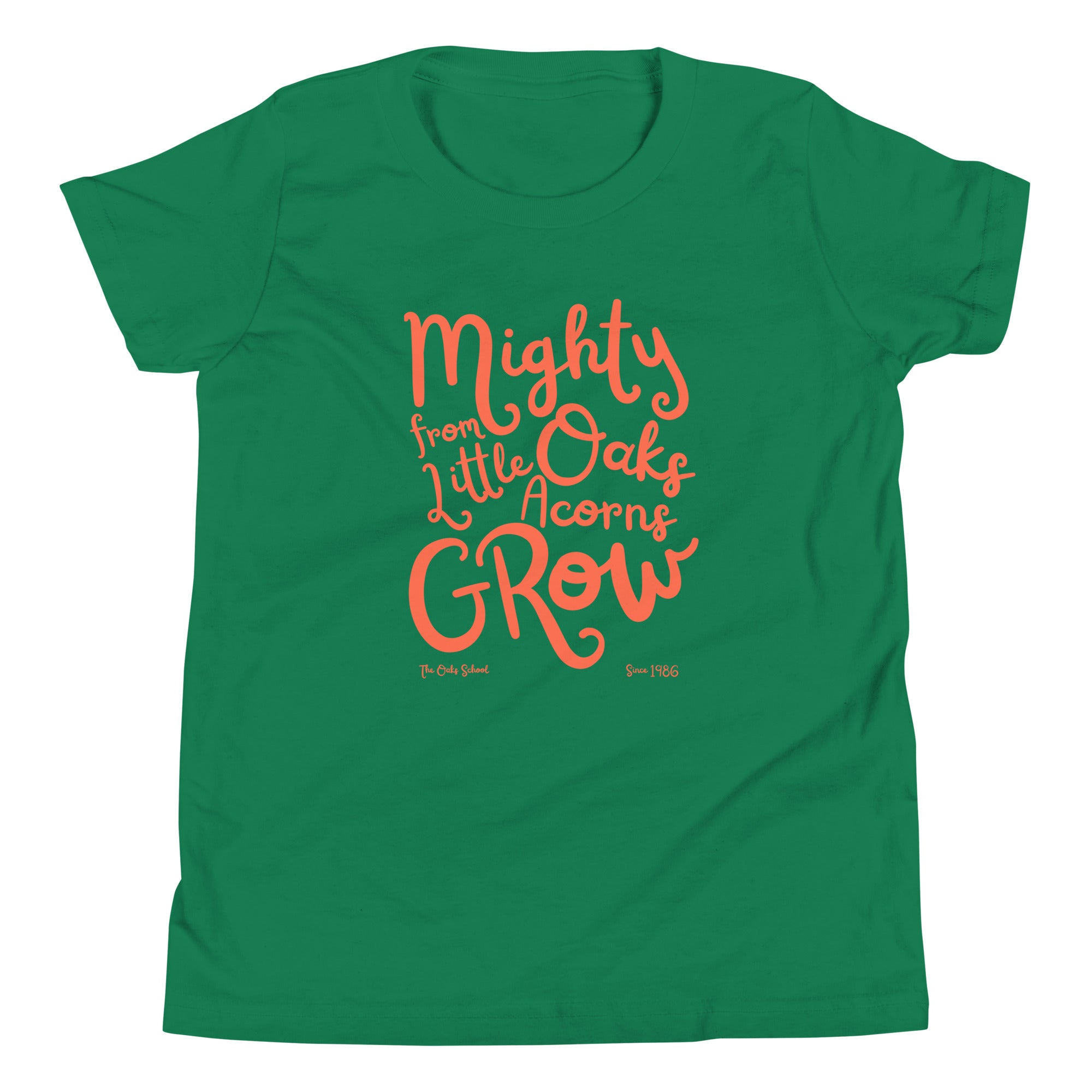 Product mockup: A kelly green tshirt on a white background with orange script text that says "Mighty Oaks from Little Acorns Grow" and "The Oaks School Since 1986"