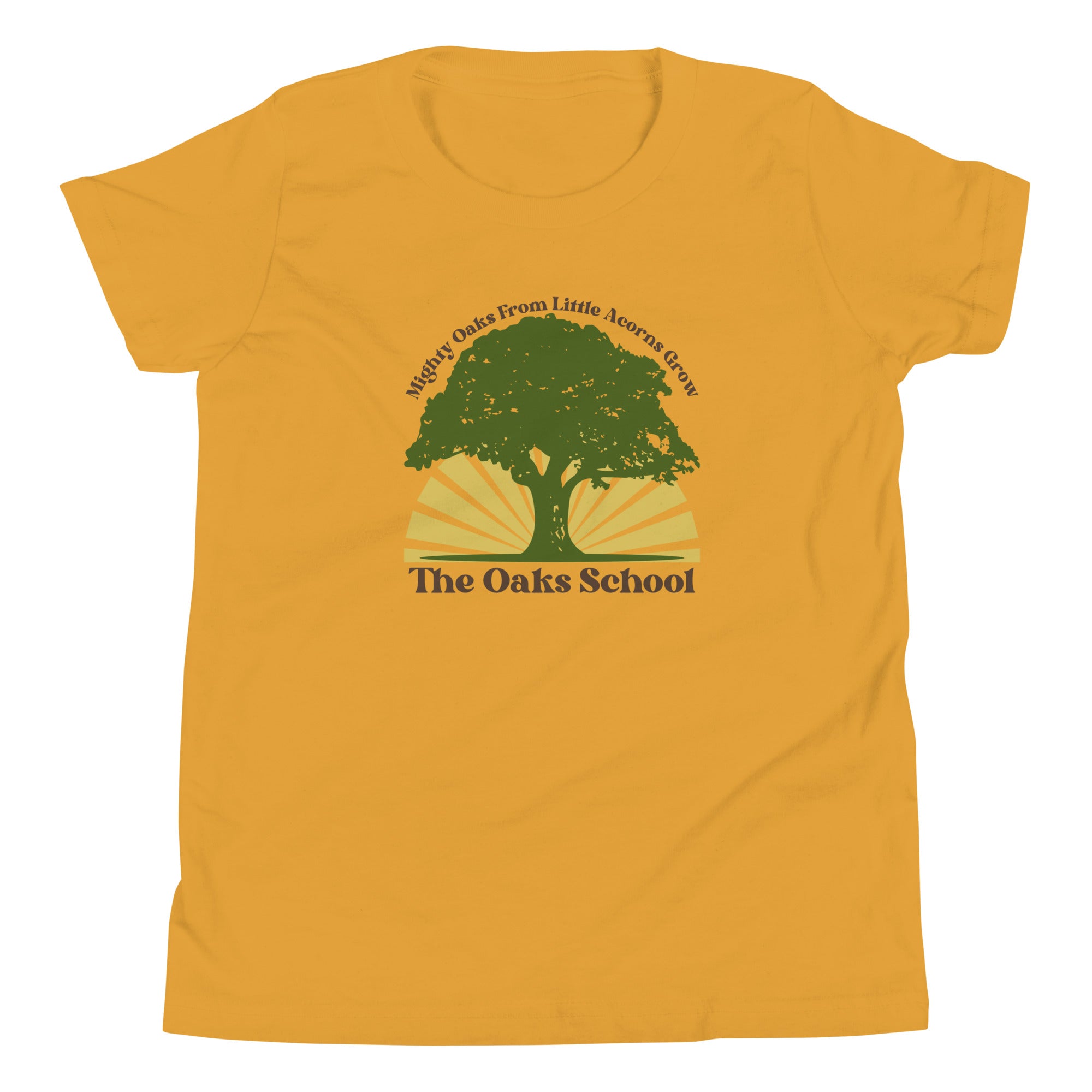 Product mockup: A mustard yellow tshirt on a white background featuring a green oak tree illustration on a yellow sunburst with text that says "Mighty Oaks from Little Acorns Grow" and "The Oaks School"
