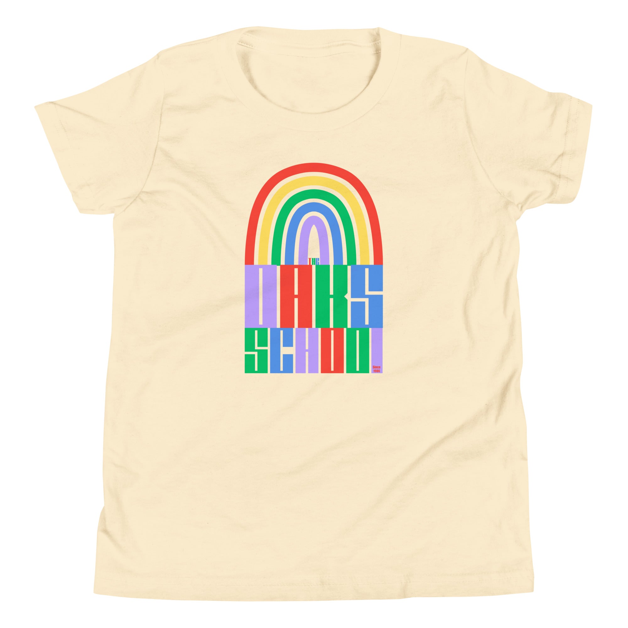 Product mockup: A natural colored tshirt on a white background featuring a rainbow illustration flowing into rainbow colored block letters that say "The Oaks School"