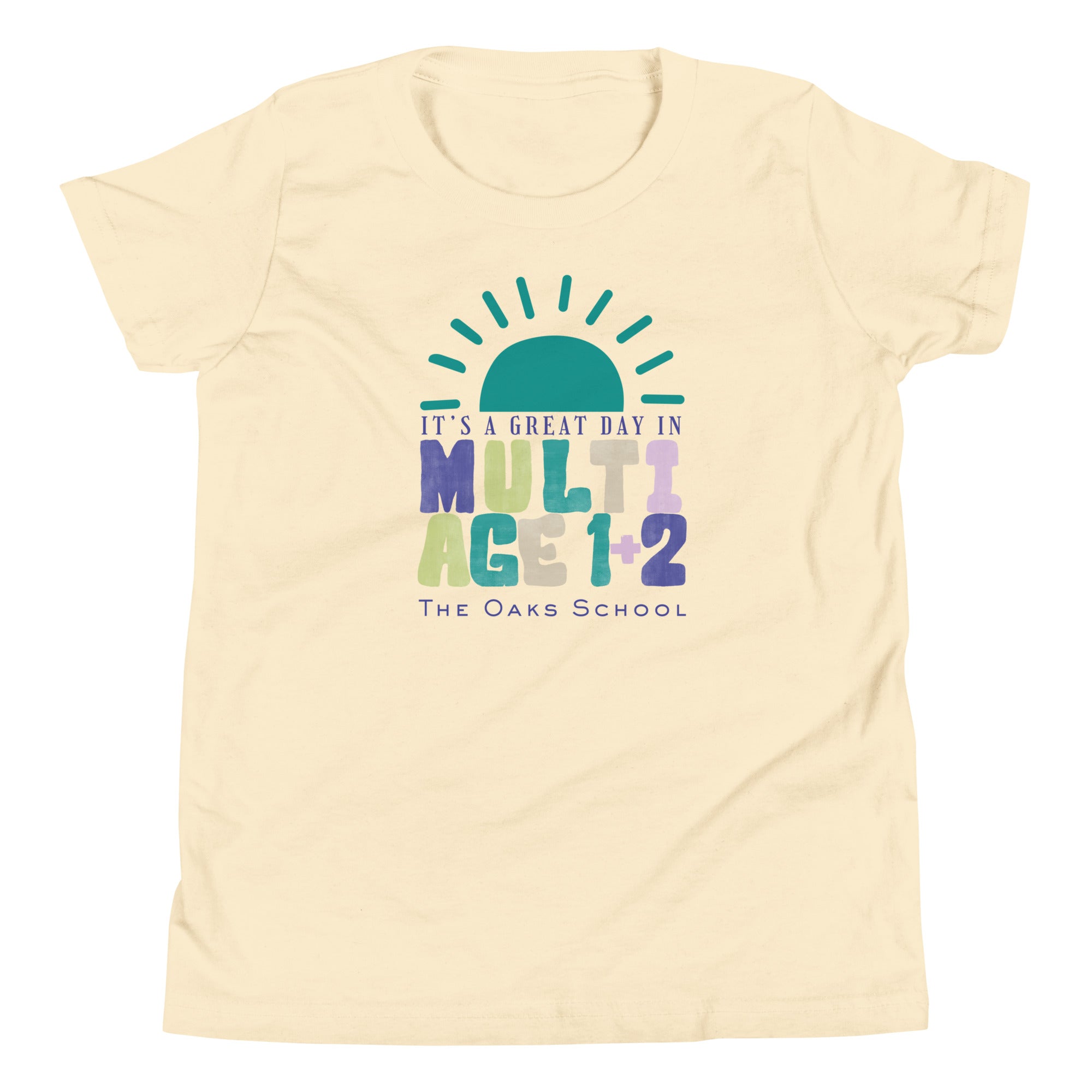 Product mockup: Image of natural colored tshirt with a half sun on the horizon and text below that reads "It's a great day in Multiage 1+2" and "The Oaks School"