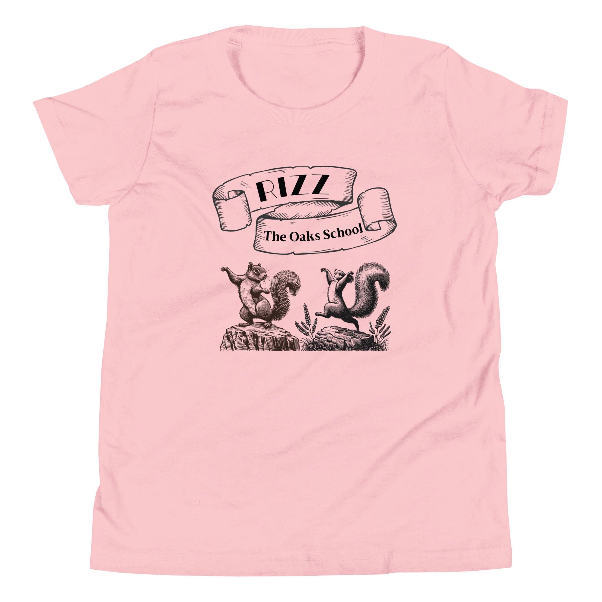 Product mockup: A pink tshirt on a white background featuring an illustration of two squirrels dancing on stumps with a scroll above them with the text "Rizz" and "The Oaks School."