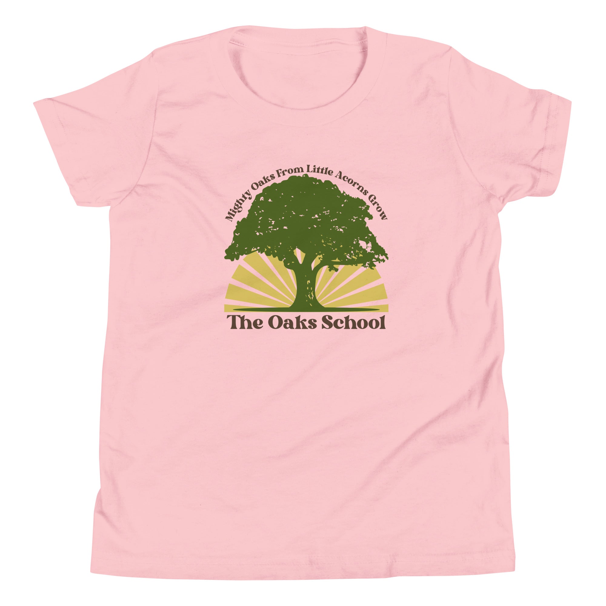 Product mockup: A pink tshirt on a white background featuring a green oak tree illustration on a yellow sunburst with text that says "Mighty Oaks from Little Acorns Grow" and "The Oaks School"