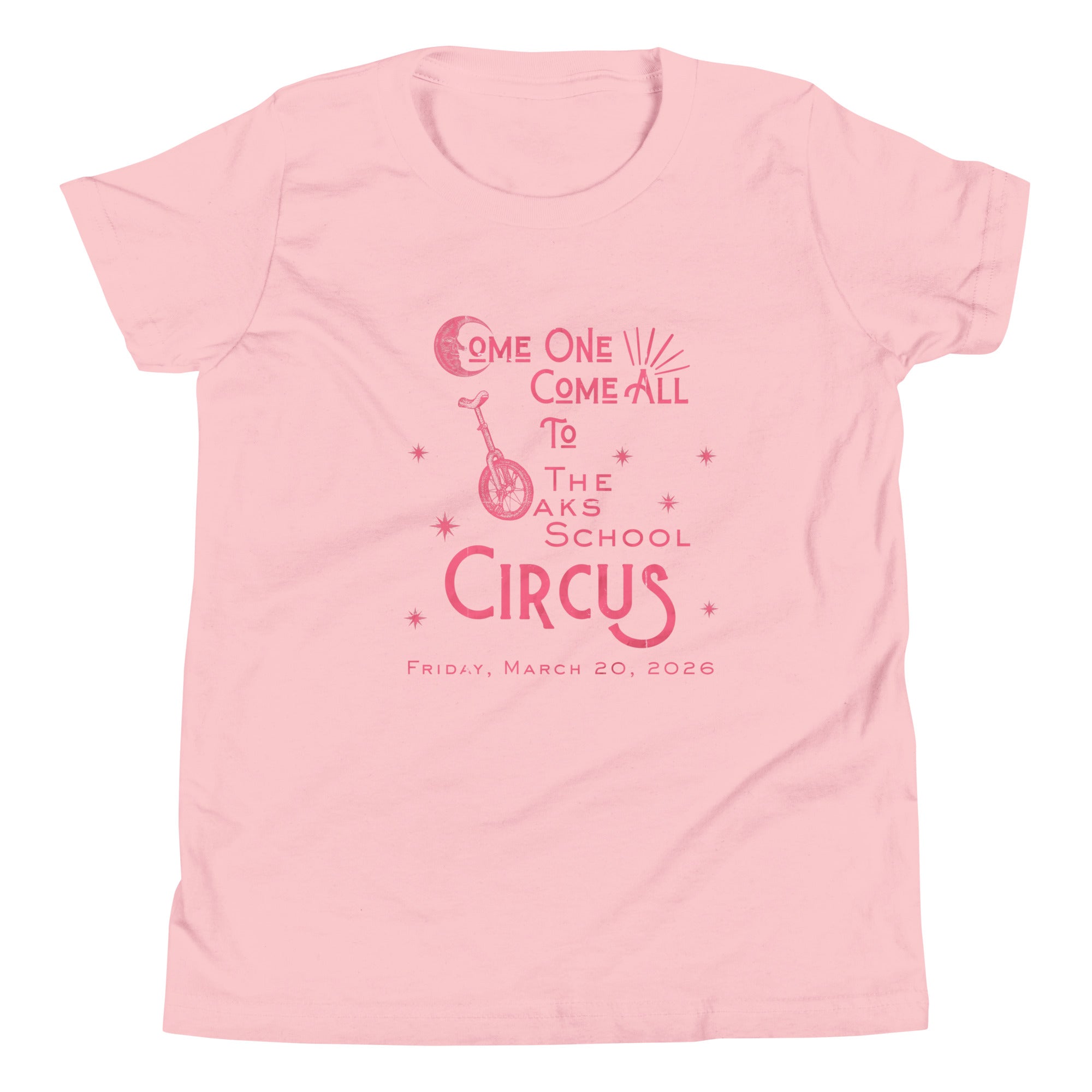 Product mockup: Pink tee with pink, weathered text "Come one, Call All to The Oaks School Circus, Friday, March 20, 2026." The "O" in "Oaks" is a unicycle wheel, the "C" in the first "Come" is a crescent moon, and there are stars sprinkled throughout.