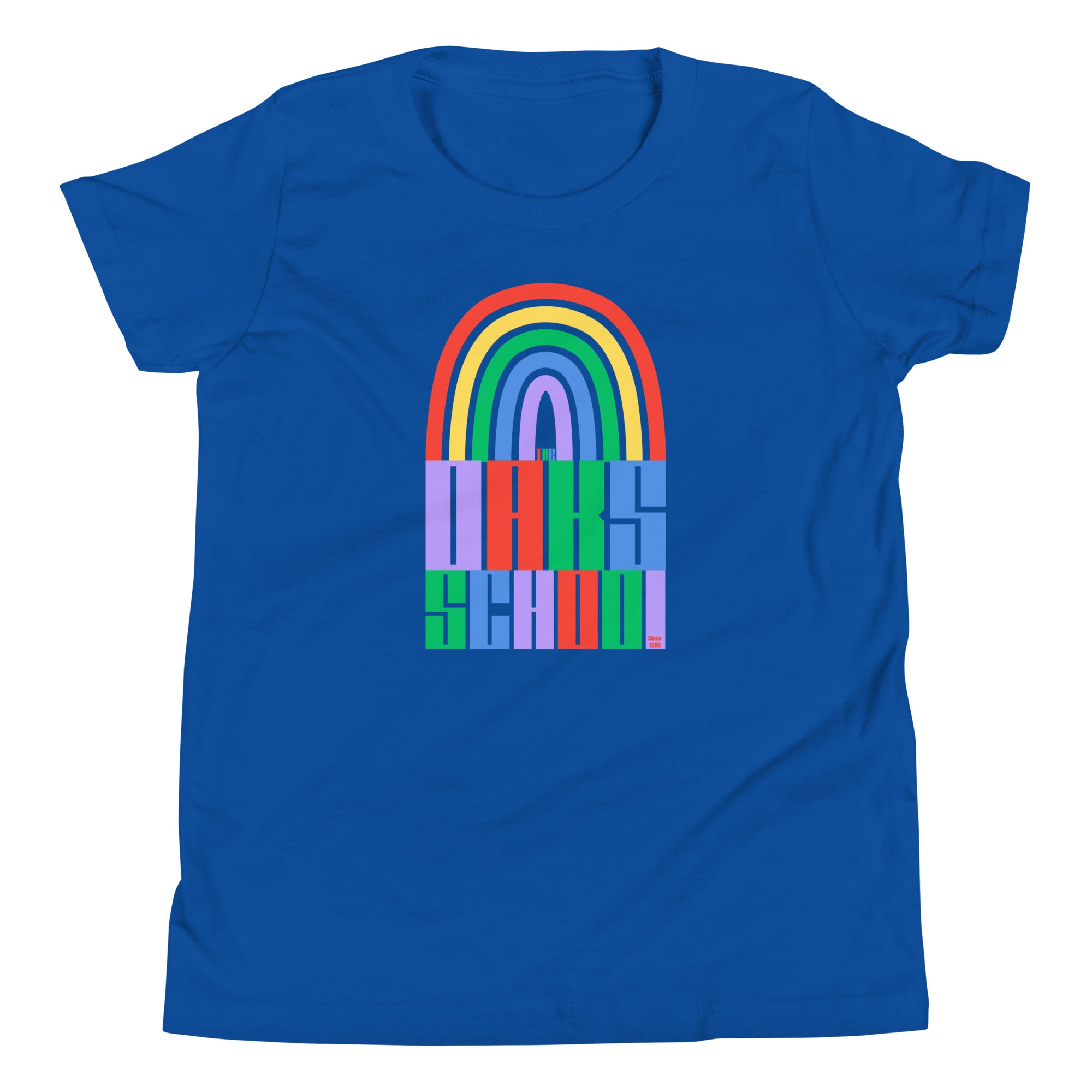 Product mockup: A royal blue tshirt on a white background featuring a rainbow illustration flowing into rainbow colored block letters that say "The Oaks School"