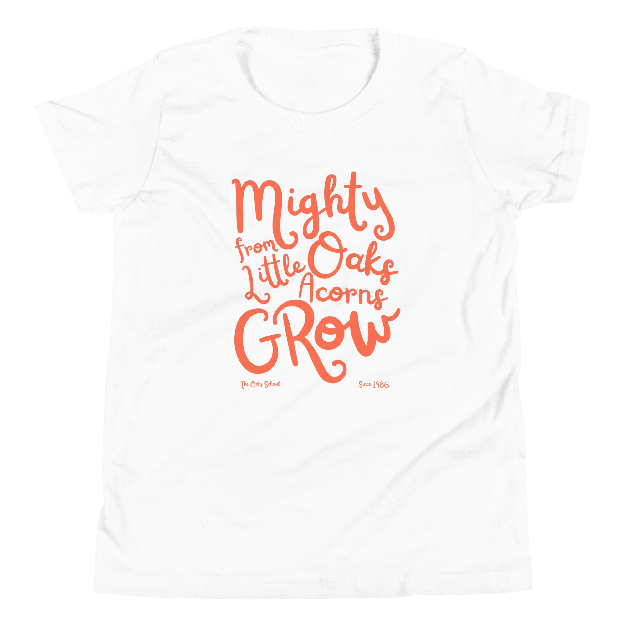 Product mockup: A white tshirt on a white background with orange script text that says "Mighty Oaks from Little Acorns Grow" and "The Oaks School Since 1986"
